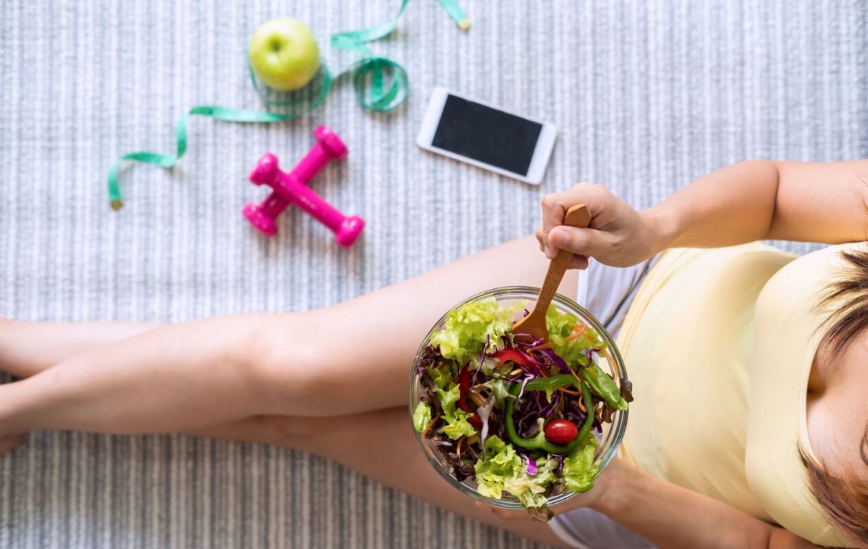 young-woman-eating-homemade-healthy-salad-at-home-2023-11-27-04-51-57-utc (1)